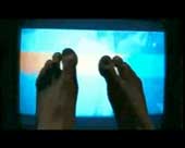 feet in front of TV